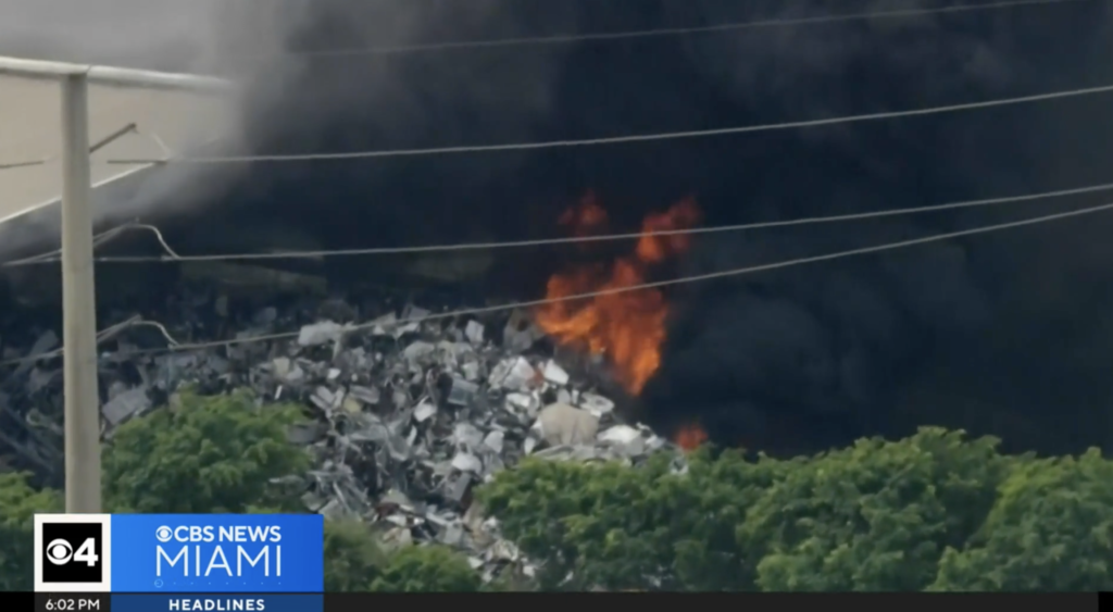 Thick black smoke rising from scrap metal fire at Miami-Dade recycling facility, April 2025