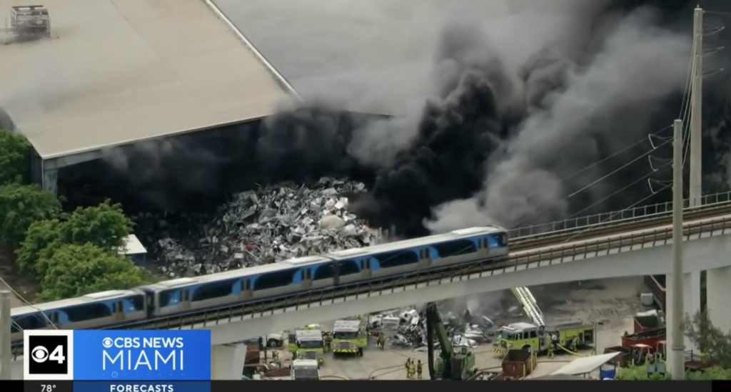 Thick black smoke rising from scrap metal fire at Miami-Dade recycling facility, April 2025